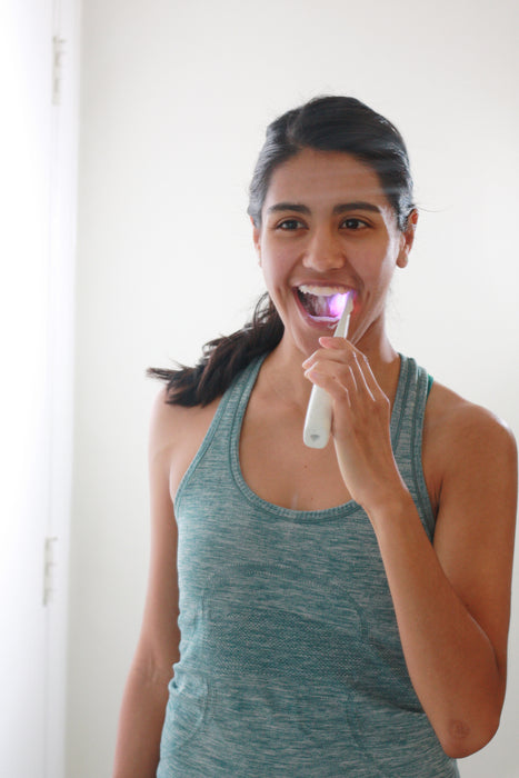 Woman using Bristl toothbrush